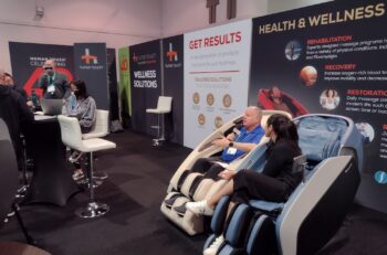 Dave interviewing guest while sitting in massage chairs