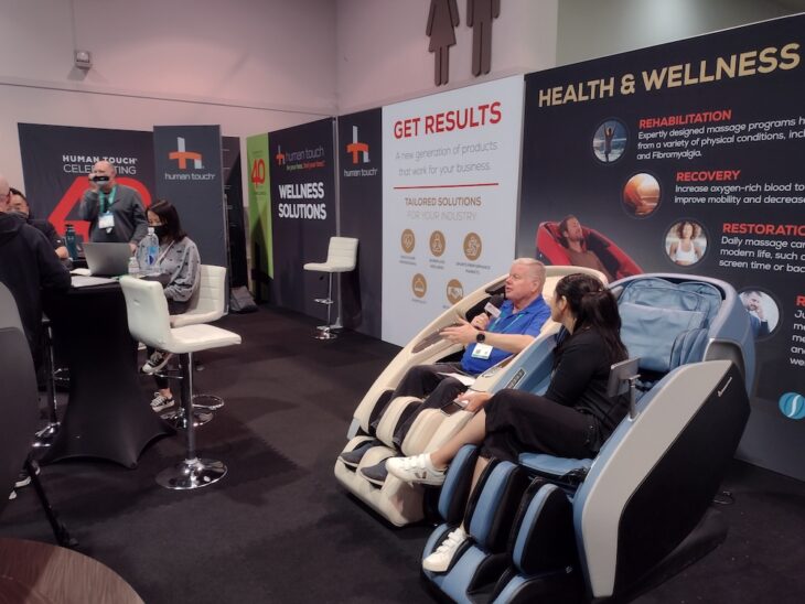 Dave interviewing guest while sitting in massage chairs